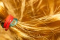 Red and blue hair tie for hair on bright yellow artificial hair