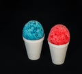 A red and blue Hawaiian Shave ice desserts on a black background.