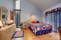 Red and blue interior of vaulted ceiling bedroom in American style. Royalty Free Stock Photo