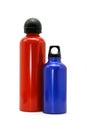 Red and blue metallic bottles on white