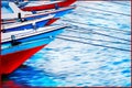 Red and blue old boats in the seaport. Colored reflections in the water. Sea background