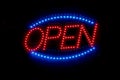 Red and blue open sign welcomes customers Royalty Free Stock Photo