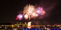 Red, blue, and orange fireworks over the Saint-Lawrence River Royalty Free Stock Photo