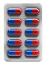 Red and blue pills in blister packaging isolated on white background