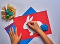 red blue purple sheet of paper with easter white hare