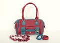 Red and blue purse with matching necklace and bracelets.