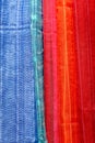 Red and blue scarves at local market, India