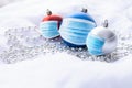 Red, blue and silver Christmas baubles with blue surgical face masks on white background Royalty Free Stock Photo