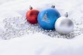 Red, blue and silver Christmas baubles on white background Royalty Free Stock Photo