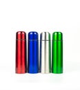 Red, blue, silver and green thermos bottles isolated on white background Royalty Free Stock Photo