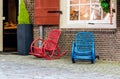 Red and blue street rocking-chair at the entrance to sweet shop