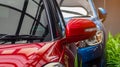 Red and blue SUV car parked on concrete parking lot of the hotel, home, or apartment. Automotive industry. Electric or hybrid car Royalty Free Stock Photo