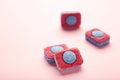 Red and blue tablets for dishwashing machine. Detergents for home hygiene. Dishwasher capsules on pink background Royalty Free Stock Photo