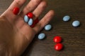 Red and blue tablets in hand Royalty Free Stock Photo