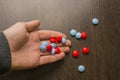 Red and blue tablets in hand