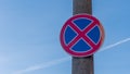 Red and blue traffic sign in front of beautiful blue sky says absolute no stopping here also on the hard shoulders. Royalty Free Stock Photo