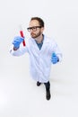 High angle view of young chemist, doctor conducts chemical research isolated on white background. Concept of Royalty Free Stock Photo