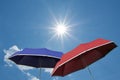 Red and blue umbrella, bright sunny sky Royalty Free Stock Photo