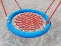 Red and blue wicker swing. Fastening elements of structures on the bright playground.