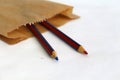 Red and blue wooden pencils in craft paper bag Royalty Free Stock Photo