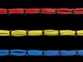 Red, blue and yellow cables - tied together with black zipties Royalty Free Stock Photo