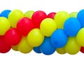 Red, blue and yellow celebration balloons in stack isolated Royalty Free Stock Photo