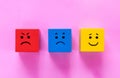 Cubes with cute faces depicting human emotions: anger, sadness and happiness