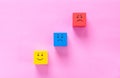 Cubes with cute faces depicting human emotions: anger, sadness and happiness