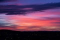 Red-blue-yellow fiery, burning like a flame the evening sky. Beautiful red-blue sunset over city plans with clouds. Dark Royalty Free Stock Photo