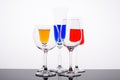 Red blue and yellow liquor syrups in glass glasses1 on white background