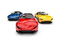 Red, blue and yellow modern electric sports cars racing - front view shot