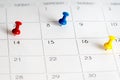 Red blue yellow pins on calendar Royalty Free Stock Photo