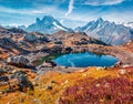 Red blueberry leaves cover the mountain slopes. Sunny autumn view of Cheserys lake Lac De Cheserys, Chamonix location. Nice morn