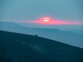 Red Blurry Sunset Time Over Karkonosze Mountains. Mist Over The Range.