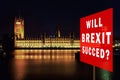 Red board with phrase & x27;Will BREXIT Succed& x27;. Brexit Concept with parliament in background at night. London, UK Royalty Free Stock Photo