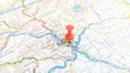 A red board pin stuck in Graz on a map of Austria