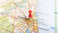 A red board pin stuck in Newcastle Upon Tyne on a map of England Royalty Free Stock Photo