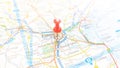 A red board pin stuck in Padova on a map of Italy