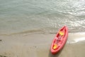 Red boat on the beach, kayak on the sand