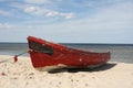 A red boat on a beach