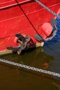 A red boat with a black anchor on it Royalty Free Stock Photo