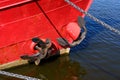A red boat with a black anchor on it Royalty Free Stock Photo