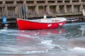 Red boat in frozen Copenhagen canal - winter season Royalty Free Stock Photo