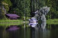 Red boat house and boat reflecting on lake Royalty Free Stock Photo