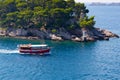 Red boat and lighthouse in water near Dubrovnik Royalty Free Stock Photo