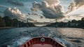 Red boat moving on canal towards bridge at sunset with dramatic sky Royalty Free Stock Photo