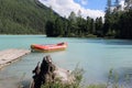 Red boat at the pier, Kucherlinskoe Lake, Belukha Natural Park, Altai Mountains, Russia