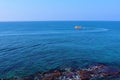 Red boat sailing on the blue water of Acre harbor, Israel Royalty Free Stock Photo