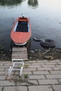 Red boat in the water on the river bank Royalty Free Stock Photo