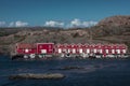 Red boathouses with boats at the coast of the archipelago island of TjÃ¶rn in the west of Sweden